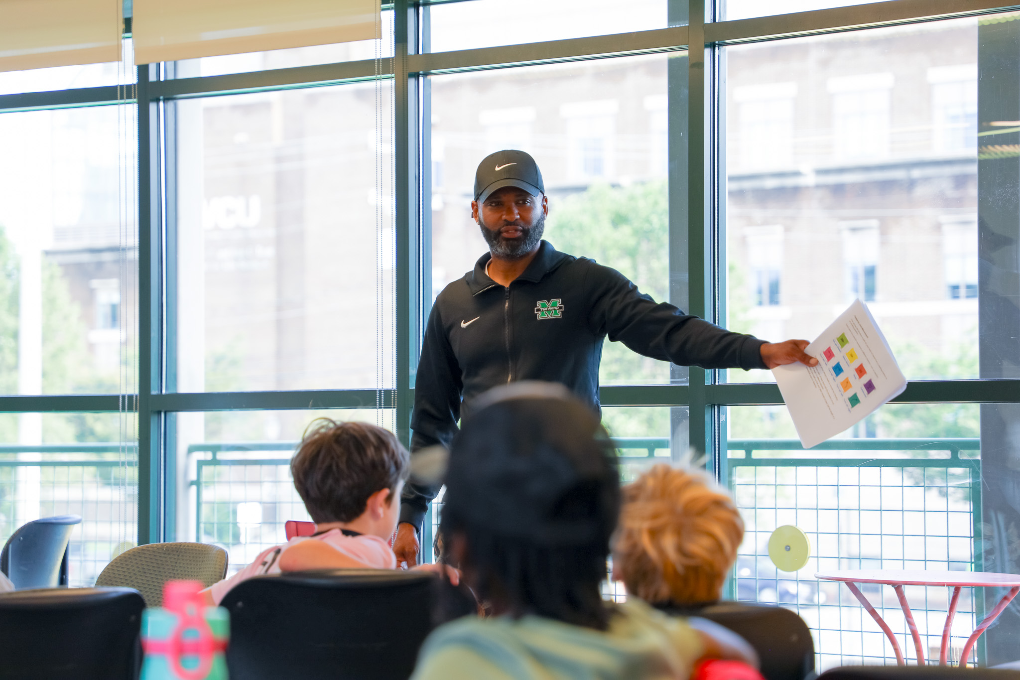 Man teaching to young kids